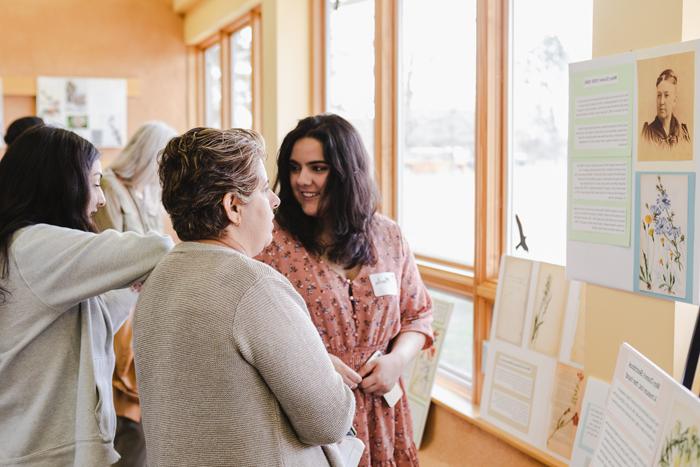 Doane University student Marilu Garcia and her family view an exhibit on artist Mary Doane at Spring Creek Prairie Audubon Center. 