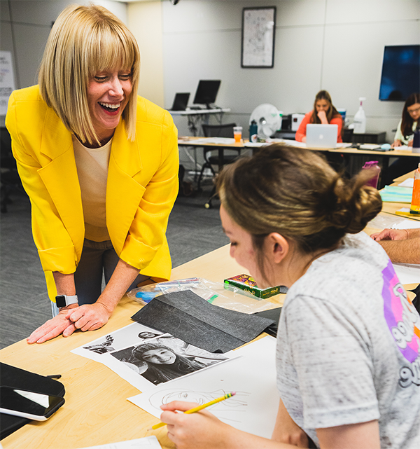 Student conversing with teacher during 2022 summer education classes