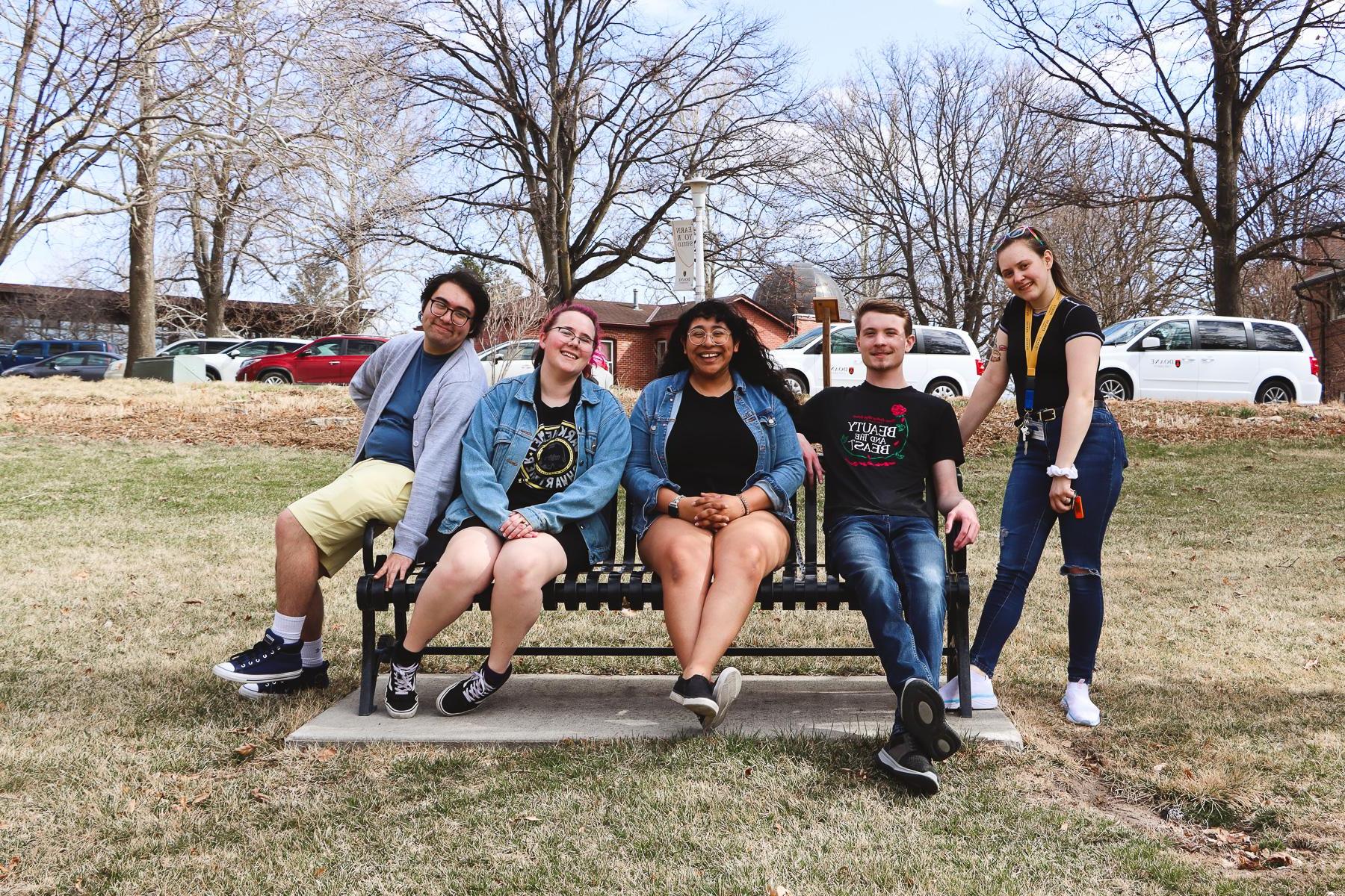 The five members of Doane's Forensics Team pose on a bench on the lawn of the Crete campus.