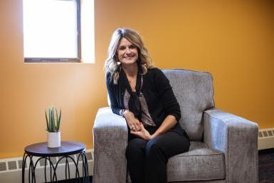 Darcy Dawson ‘04 ‘10C sits next to the window in her office, room 306 in the Fred Brown Center on Doane's Lincoln campus location. 